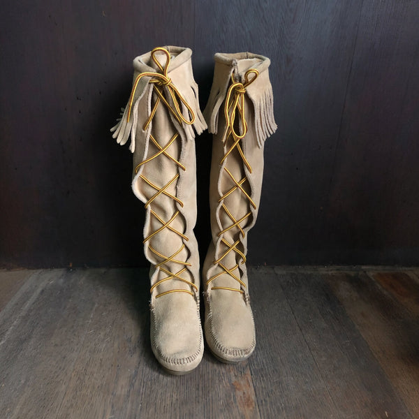 Minnetonka tall beige size 7 leather moccasins with lace front view with fringe boot