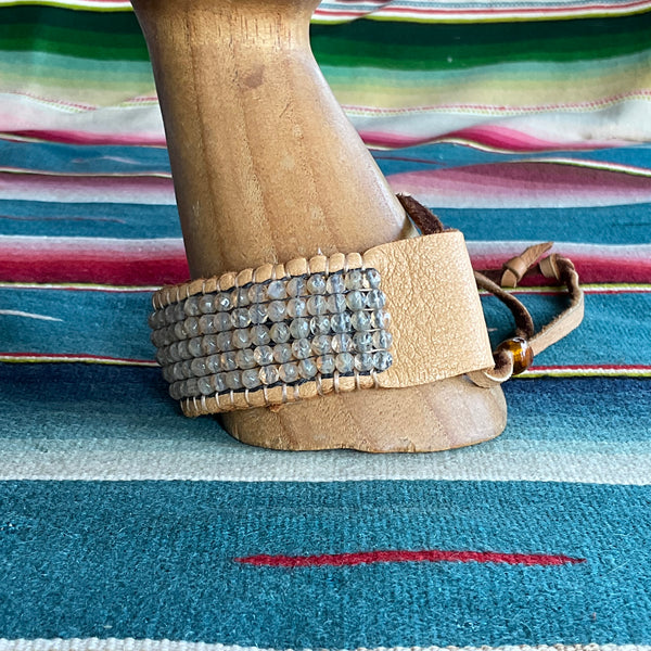 citrine beaded bracelet on gold leather on arm mannequin blue background side view close up stormie art bracelet