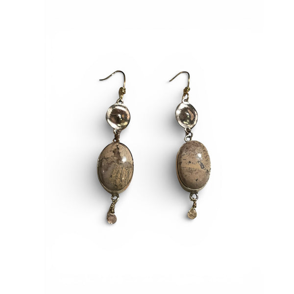 Pair of earrings with brown oval stones on a white background