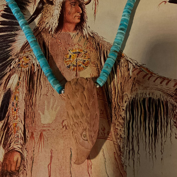 Traditional Native American headdress with turquoise elements and feathers on a neutral background