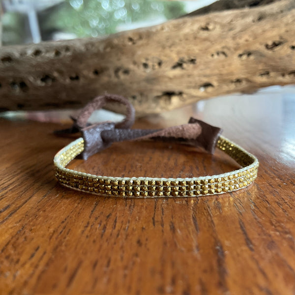 Gold antique seed beaded bracelet with Stormie signature leather tie adjustable closure