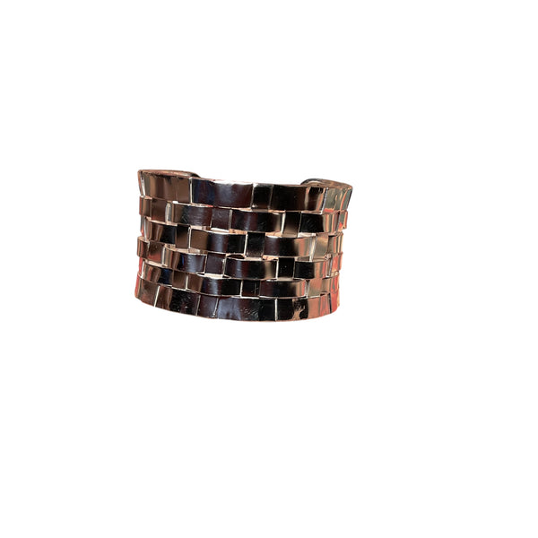Woven bracelet with brown and silver pattern on a white background