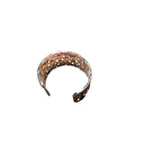 Decorative headband with cut-out design on a white background