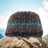 handmade beaded bracelet set on rock under blue sky 